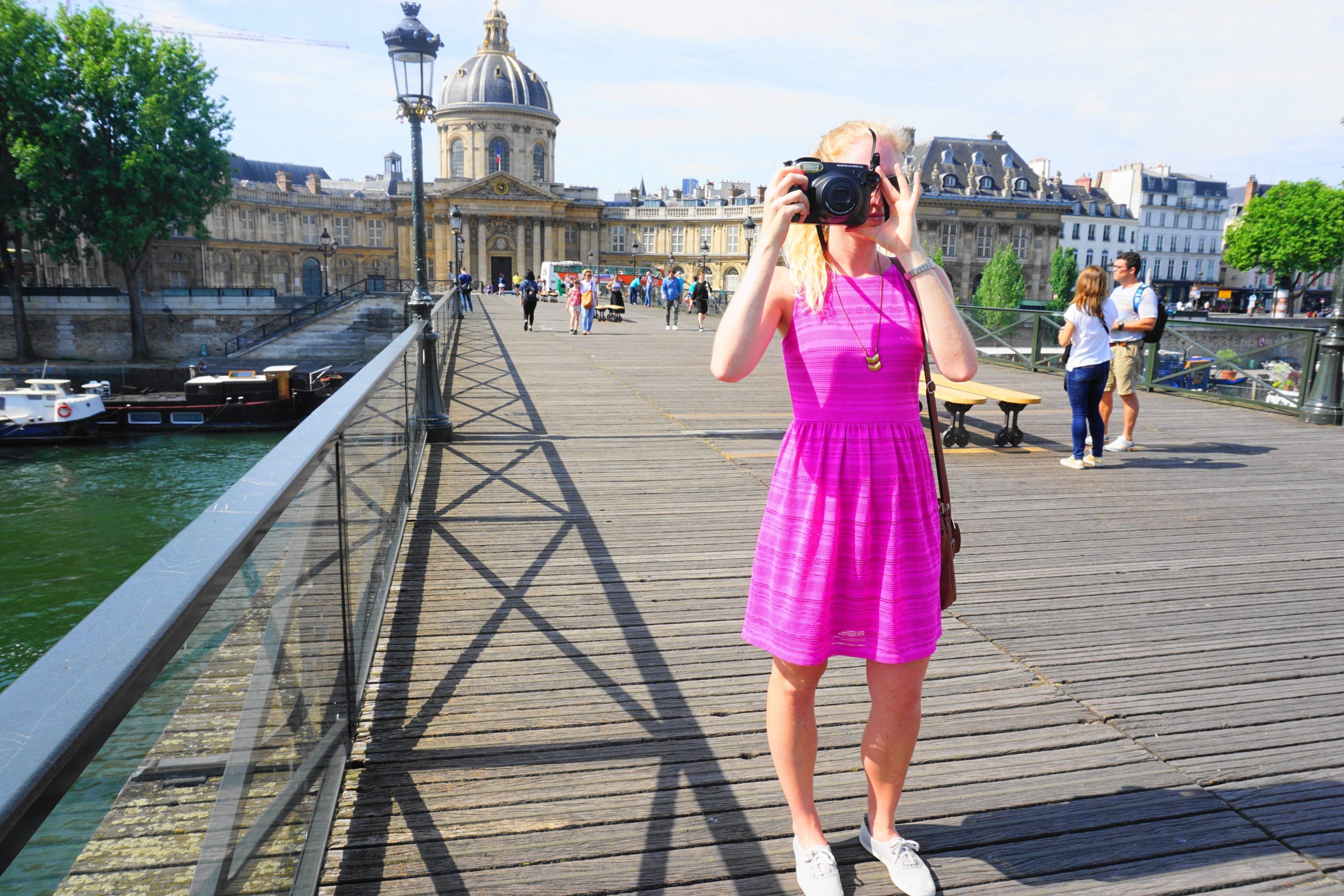 taking a photo on a bridge in Paris