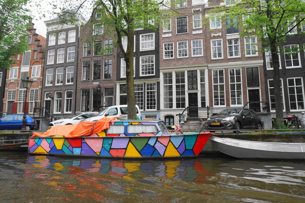 Amsterdam canals with colorful houseboat